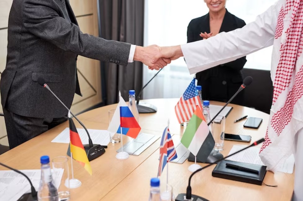 Two intercultural delegates shaking hands after a successful meeting